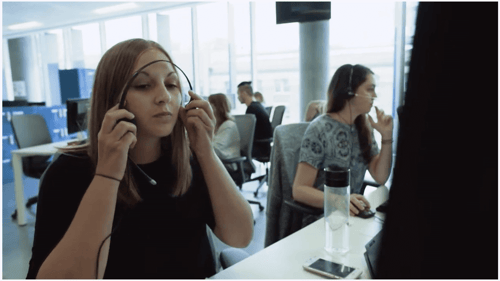 JustGiving Video Case Study Woman putting on headset in contact center environment