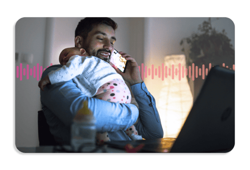 Directory Assistance A smiling father holding a sleeping child while using a mobile phone