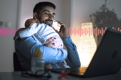 Directory Assistance A smiling father holding a sleeping child while using a mobile phone