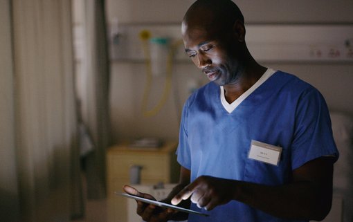Doctor Shot of a medical practitioner using a digital tablet in a hospital ward