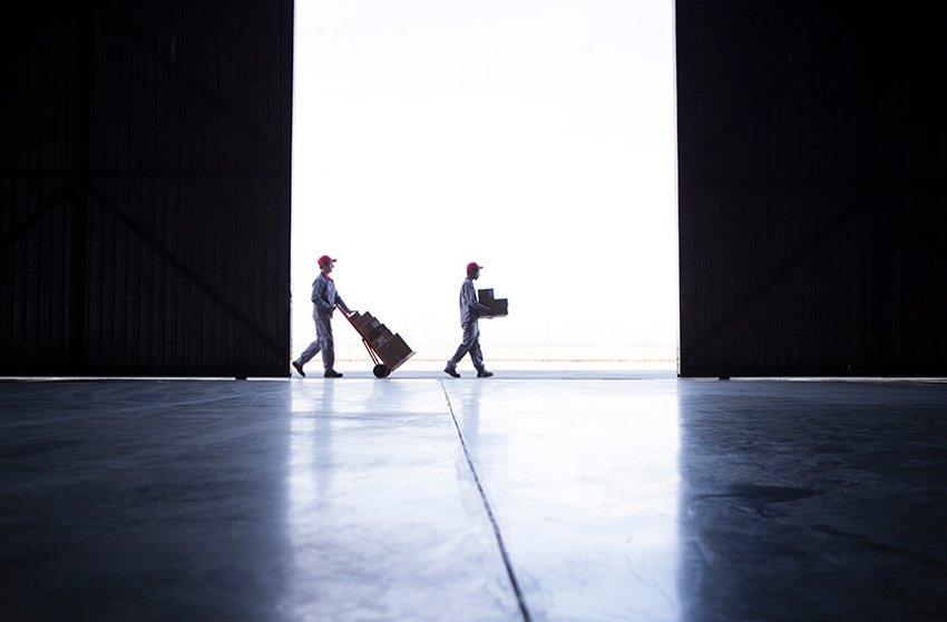 two people at a distance moving boxes